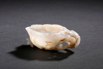a close up of a piece of white marble on a black surface