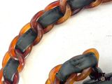an orange and black bracelet with a black clasp on it