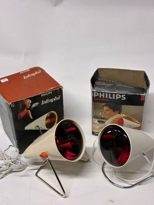 pair of white lamps with red lights and a box on a white surface