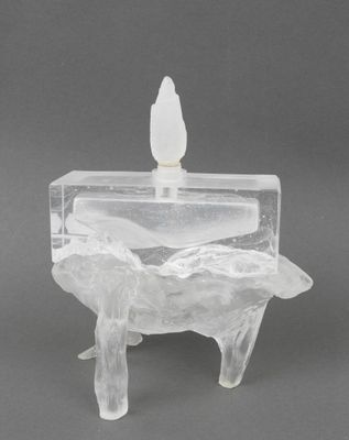 an image of a clear glass candle holder with a bird on top of it