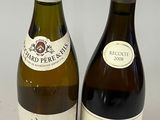two bottles of wine sitting next to each other on a table