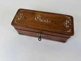 a small wooden box with a name on it