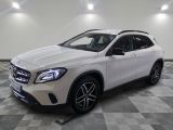 a white mercedes gla suv parked in a garage