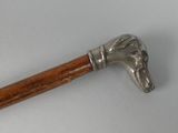 a silver and wood walking stick with a horse head on it