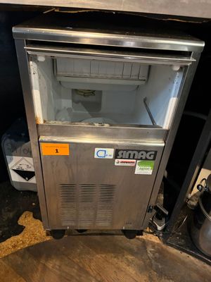 une photo d'un petit réfrigérateur dans une cuisine sale