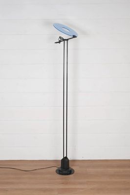 the floor lamp has a blue shade on it and is on a wooden floor