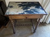 a small table with a blue and white paint on it