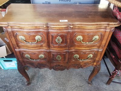 a wooden dresser with many drawers and drawers on it