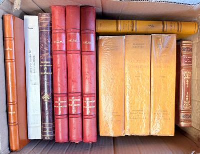 many books in a cardboard box on a table