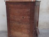 an old wooden chest of drawers in the corner of a room