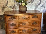 a picture of a dresser with a painting on the wall