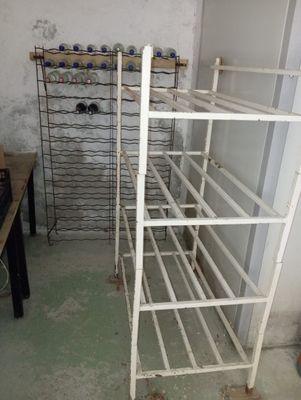 a rack of wine bottles in the corner of a room