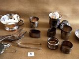 a lot of silverware on a table with a price tag