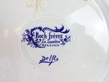 a blue and white plate with a blue design on it
