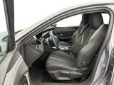 the interior of a car with the door open and the driver ' s seat down