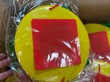 a person holding a yellow and red toy in a box