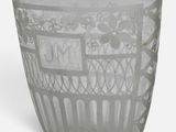 a glass cup with a design on it on a white surface