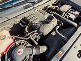 a car engine with the hood open on the street