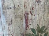 a painting on the wall of a vase with a plant on it