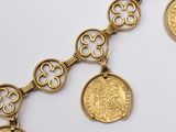 an image of a gold bracelet with coins on a white background