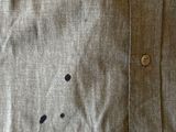 a close up of a shirt with holes on it