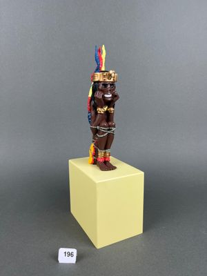 a close up of a figurine of a man with a feather on his head