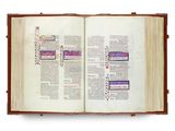 an open book on a white surface with a picture on it