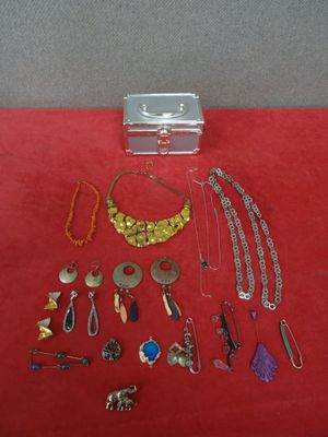 an assortment of jewelry is displayed on a red surface