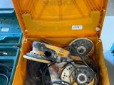 a yellow tool box with tools in it on a table