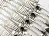 a lot of silver spoons and forks on the table