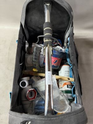 a bag filled with tools and other items on a table