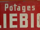 une enseigne rouge sur laquelle est écrit « Potatoes Liebig »