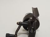 a fishing reel that is sitting on a table