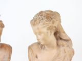 two statues of a woman and a man standing next to each other