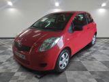 a picture of a red toyota yaris parked in a garage