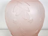 a pink vase sitting on a table with a white background