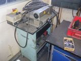 a machine that is sitting on a workbench in a garage
