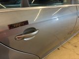 a silver car with a sticker on the side of it