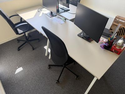 a desk with two monitors and a laptop on it