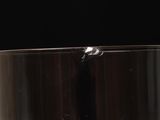 a glass filled with liquid on a black background