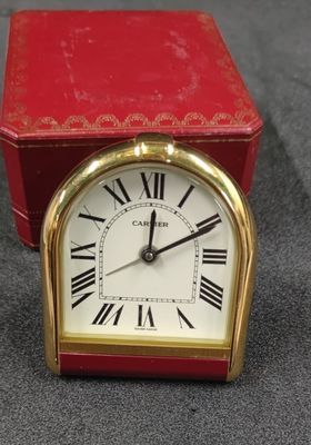 a small red box with a clock inside of it