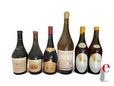 several bottles of wine are lined up on a white surface