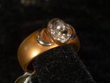 an image of a gold ring with two diamonds