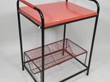 an image of a red and black cart with two shelves