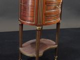 a small wooden table with drawers and a shelf on top of it