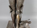 an image of a statue of a man in armor with a dog