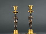 pair of bronze candlesticks with figures of a man and a woman