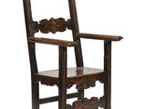 an old wooden chair with a carved back and seat