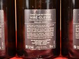 three bottles of wine sitting on top of a red table