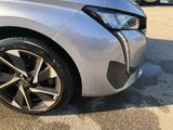 a close up of a car ' s front tire with a sticker on it